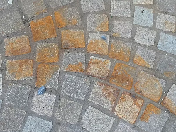 Close up of rust stains on stone pavers.